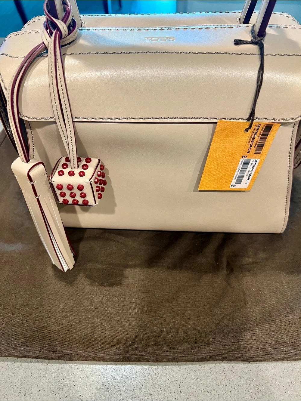 TOD'S structured satchel in delicate leather featuring contrast dark red trim